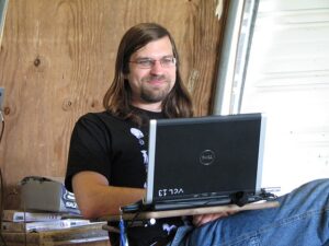 Rev. Dangler, with long hair, presents at the Trillium Gathering