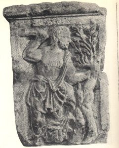 A man in a tunic uses a tool to shear branches from a tree; ESVS inscribed above him