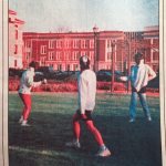 Three men in fencing gear face off on a grassy patch. The caption states they are "unidentified"