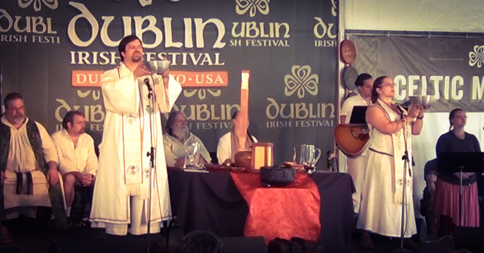 Rev. Dangler and Rev. Avende hold bowls up on stage