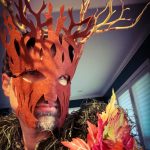 Selfie of MJD in a tree mask with branches, and foliage and autumn leaves pinned to his shirt