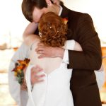 MJD kisses his wife at his wedding; one of her shoulder straps is dangling from her dress