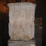 Bearded man chopping at a tree; ESUS written above