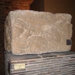 A bearded man with club or torch strikes a snake or holds a bow