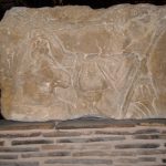 Figure with horse and lance, head and top of column sheared off