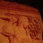 Esus with an orange-red filter, from the hips up