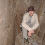 MJD kneeling in a rock crevasse