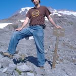 MJD on Mt. Rainier, next to a sign that says, "End of maintained trail"