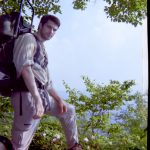 MJD with backback on a rock overlooking a valley