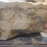 Three figures, two looking out and one in profile, inscription SENANT V