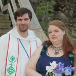 MJD and a woman with red hair and a purple dress, and irises in her hands