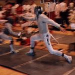 Two sabre fencers; the one on the left is female, and the one on the right has "Dangler" written on his leg