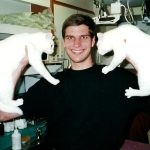 MJD holds two all-white cats up.