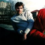 MJD in fencing gear, lounging on a ledge overlooking the OSU Main Library