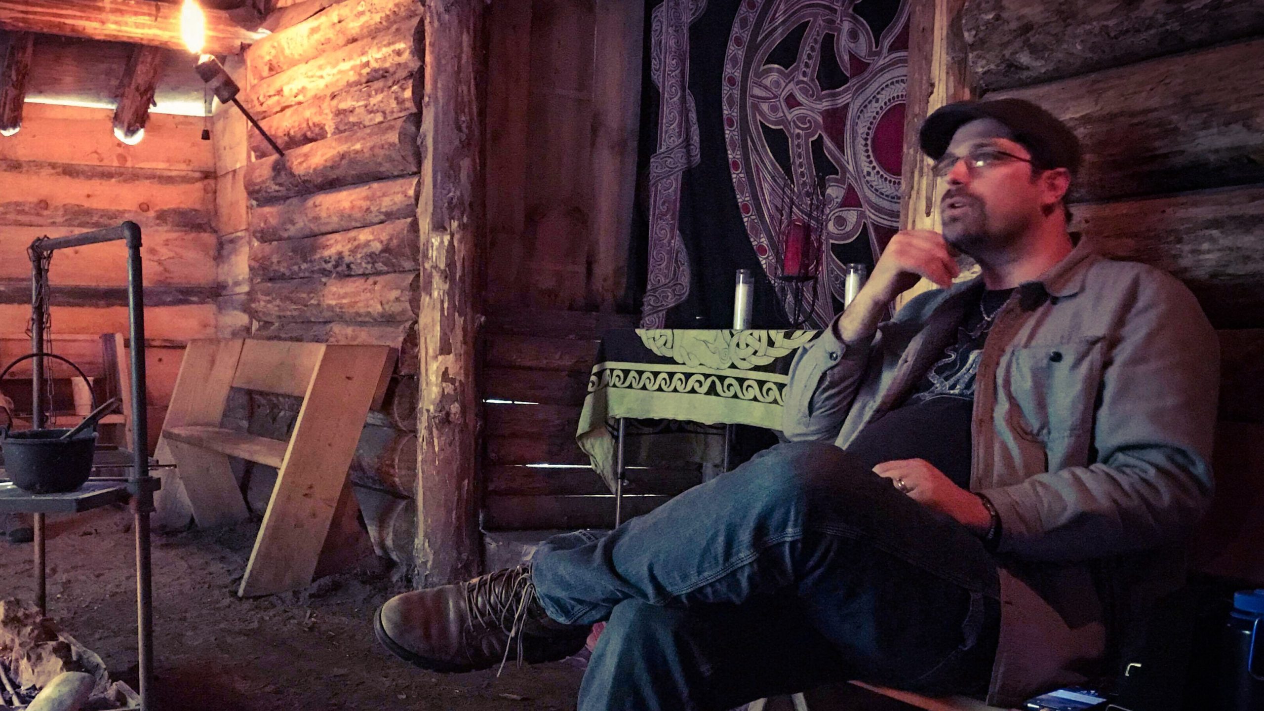 MJD presents a workshop sitting in a cabin, lit by torches