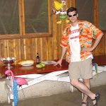 MJD in a Hawaiian shirt leans on a table with offerings