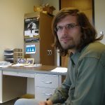 MJD with long hair in his office, 2028