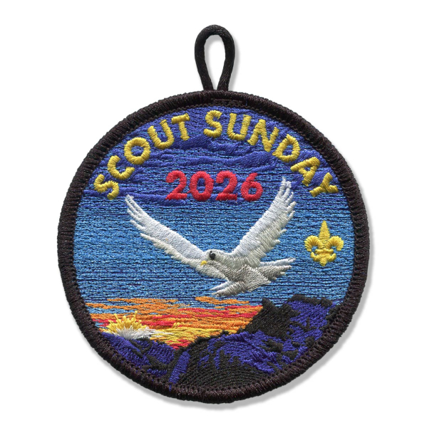 A Scout Sunday Badge from 2026 with a dove flying over a sunset in the mountains